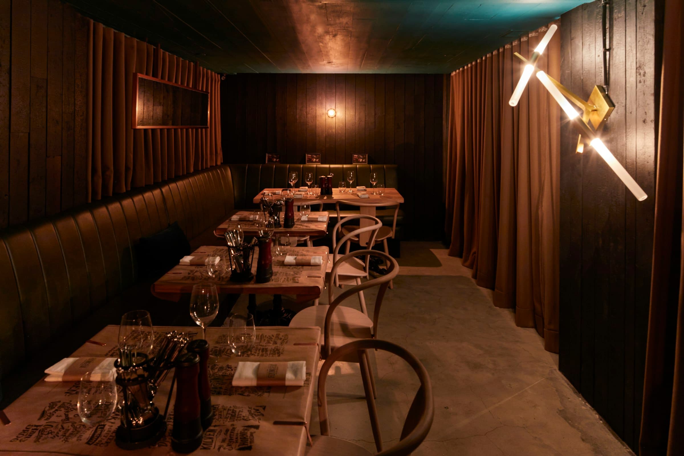 A private dining room laid for a group, warmly lit